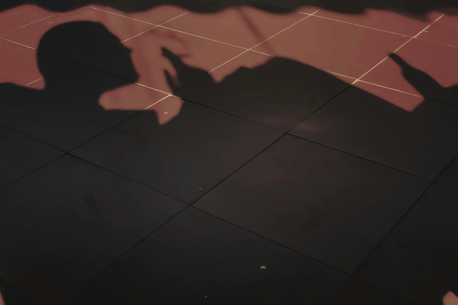 Close view of dark black floor tiles with visible joints and surface texture