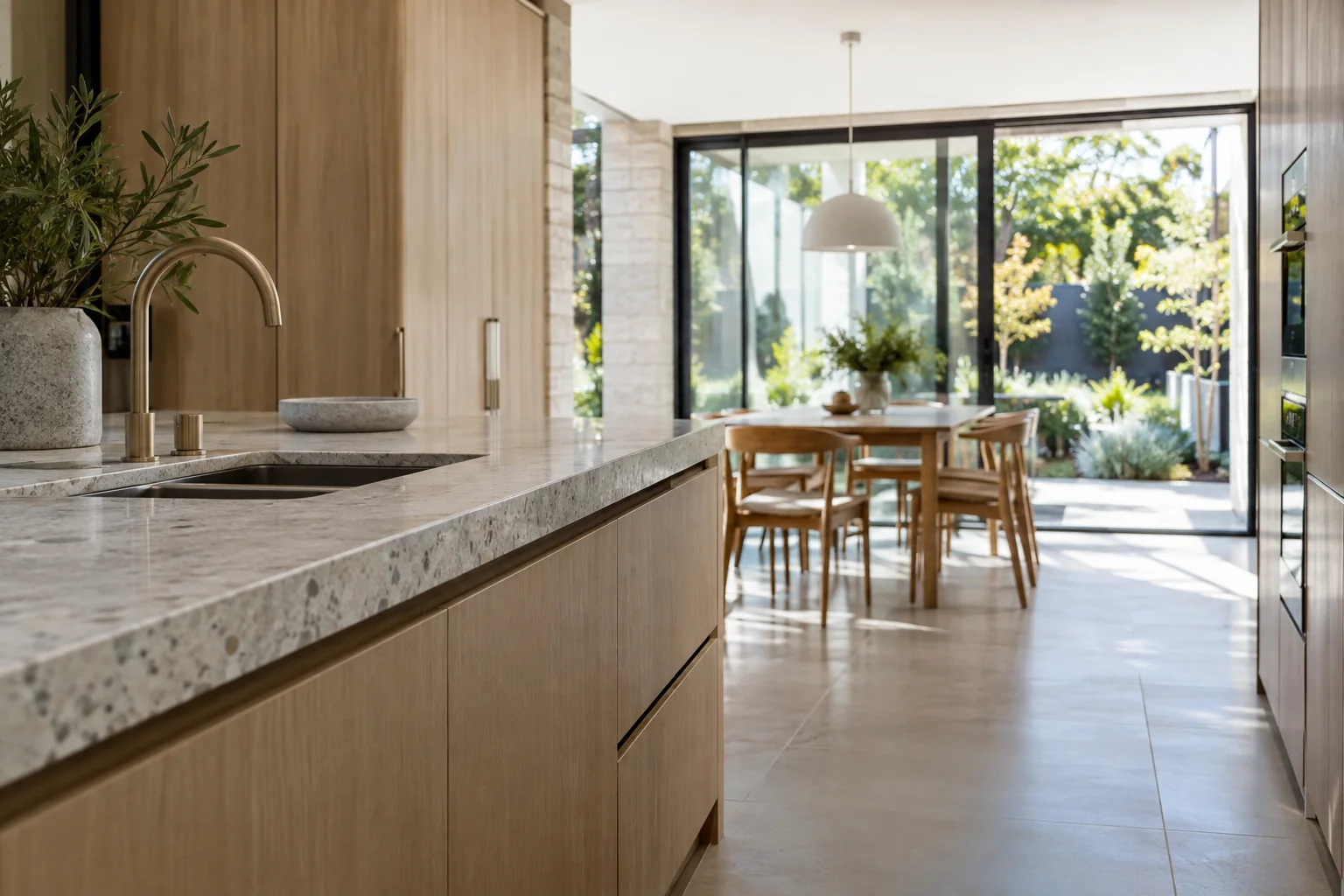 Close architectural view of a pale kitchen worktop meeting timber joinery and cabinetry